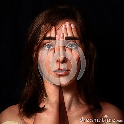 Surreal portrait of a young girl covering her face and eyes wit Stock Photo