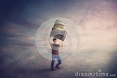 Surreal scene, angry student guy tired of constant learning, carrying huge heavy books pile over his head. Frustrated boy back to Stock Photo