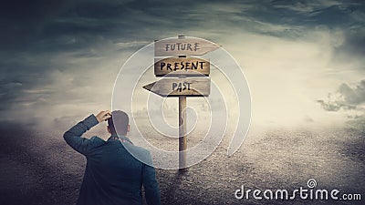 Surreal scene, businessman and a signpost arrows showing three different options, past, present and future course. Choose journey Stock Photo