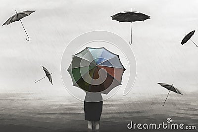 Surreal woman with colorful umbrella in the rain with flying black umbrellas around Stock Photo