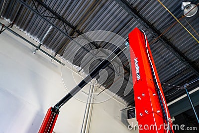 Surrey, BC / Canada - 02/24/2020: John Bean automotive lift, two post vehicle lift. In a mechanic`s garage, for working under car Editorial Stock Photo