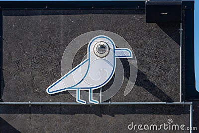 Surveilance camera disguised in a bird figure on a wall.. Stock Photo