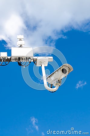 Surveillance camera on blue sky Stock Photo