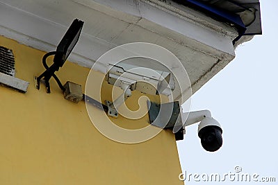 Surveillance camera mounted on tiled wall of house Editorial Stock Photo