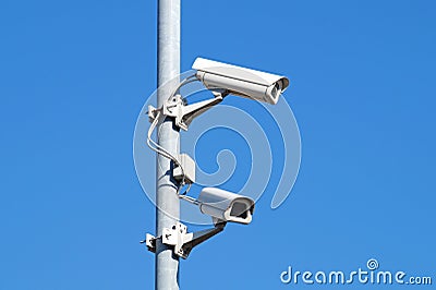Surveillance cameras against blue sky Security Cctv Stock Photo