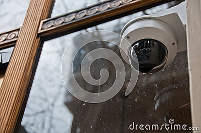 Surveillance CCTV security dome camera near office window in Europe Stock Photo