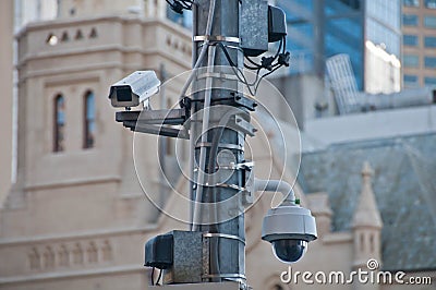 Surveillance CCTV street outdoor camera watching pedestrian near Stock Photo