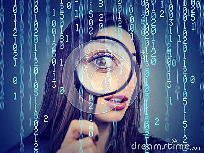 Surveillance of cyber crime concept. Curious woman looking through a magnifying glass and computer binary code background Stock Photo