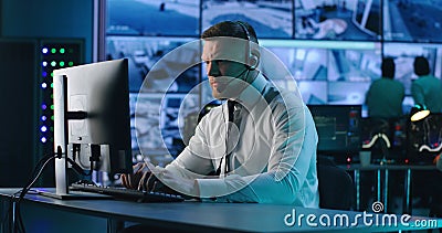 Surveillance operator browsing data on computer Stock Photo