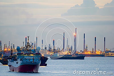 Survey and Cargo Ships off the Coast of Singapore Petroleum Refinery Stock Photo