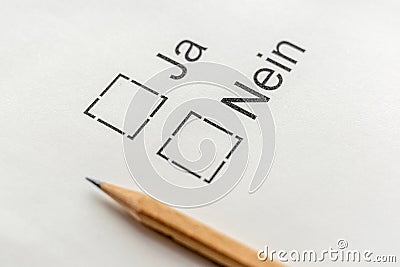 Survey vote choice Yes or NO on German language and checkbox on white paper with pencil Stock Photo