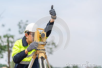 Surveyor Civil Engineer thumbs up with equipment on the construction site Stock Photo