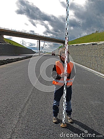 Surveyor with levelling staff Stock Photo