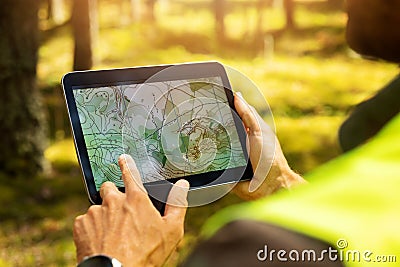 Surveyor working with forest topography map in digital tablet. land surveying Stock Photo