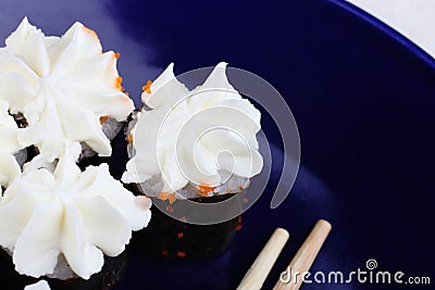 Sushi in a blue plate close-up. White sushi with Philadelphia cheese. Stock Photo