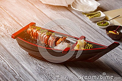 Sushi boat on wooden surface. Stock Photo