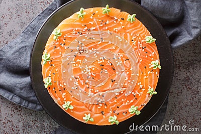 Sushi cake with a salmon, rice, avocado and philadelphia cheese closeup on the plate. Horizontal top view Stock Photo