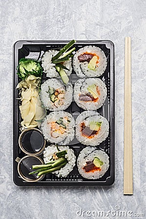 Sushi menu in black transportbox or bento box on gray background, top view, close up Stock Photo