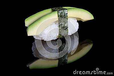 Sushi nigiri with avocado on black background with reflection. J Stock Photo