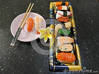 Sushi plate on black granite table Stock Photo