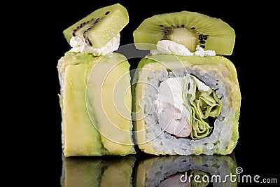 Sushi Roll with crab meat, kiwi and avocado over black backgrou Stock Photo