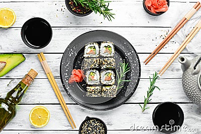 Sushi Rolls - California with sesame, salmon and avocado. Stock Photo