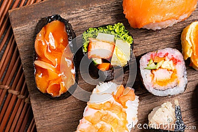 Sushi Set sashimi and sushi rolls served on wood slate. Stock Photo