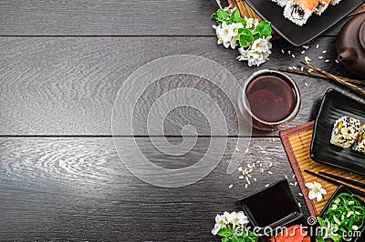 Sushi set sashimi and sushi rolls and white flowers on dark background Stock Photo