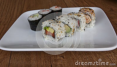 Sushi set: Uramaki sushi with rice. Seaweed hosomaki sushi. Asian traditional food. Stock Photo