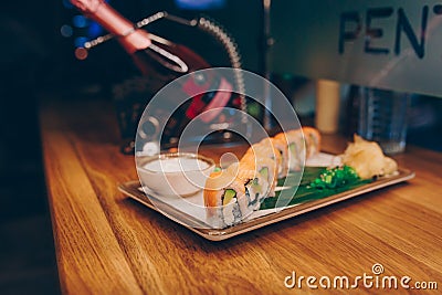 Sushi Smoked Philly plateau buffet in night dining resturant flat lay. Delicious Philadelphia salmon flesh seaweed and ginger. Rol Stock Photo