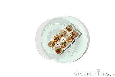 Sushi topped salmon tartare and micro greens Maki sushi with salmon in teriyaki sauce on ceramic plate. Salmon maki top tartare Stock Photo