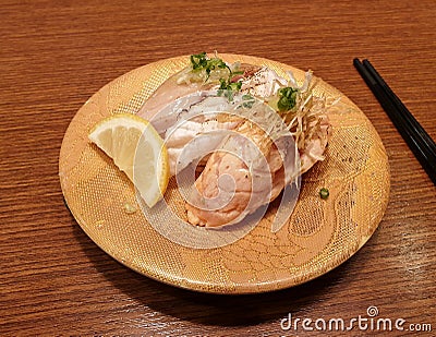 Sushi topped with slightly grilled raw fish and vegetable. Stock Photo