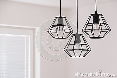 Suspended chandelier in loft style in a modern house interior. Stock Photo