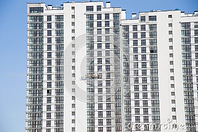 Suspended cradle on the facade of the skyscraper. Mobile scaffolding platform for construction work at height, facade cleaning, Stock Photo