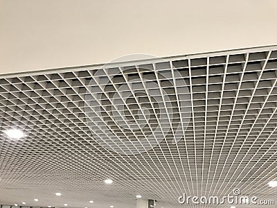 Suspended false ceiling design architectural with macro grid sizes in small for an large space commercial building interior Stock Photo