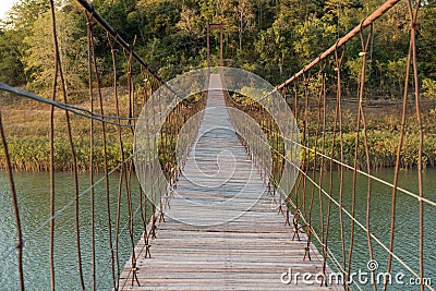 Suspension bridge made of wood and sling. Stock Photo