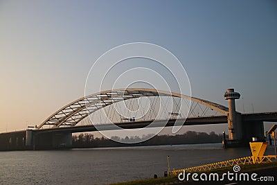 The suspension bridge named van Brienenoordbrug and offices in the morning sun in Rotterdam Editorial Stock Photo