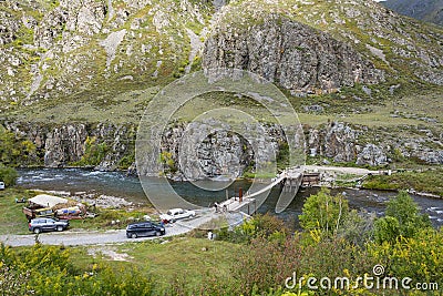 Suspension bridge over the mountain river Ursul Editorial Stock Photo