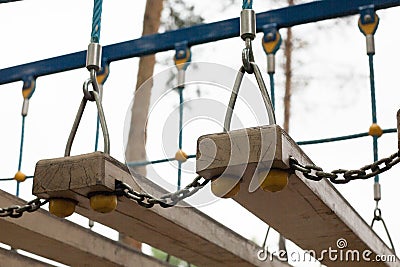 Suspension bridge with wooden steps. Focus on the boards of bridge. Stock Photo