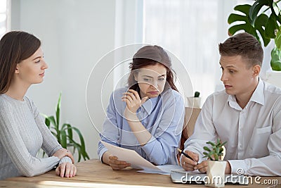 Suspicious HR managers doubt reading confident applicant resume Stock Photo