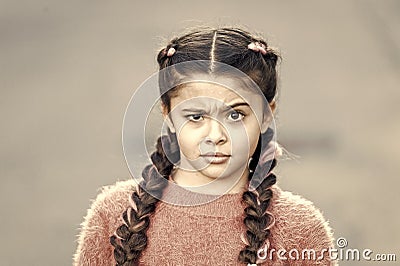 Suspicious look. Kanekalon strand in braids of child. Braided hairstyle concept. Girl with braided hair style pink Stock Photo