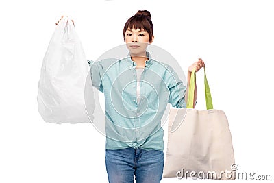 woman comparing reusable tote and plastic bags Stock Photo