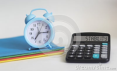 SUSTAINABLE DEVELOPMENT. Text on calculator display and white background with clock and colored folders. Stock Photo