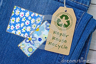 Sustainable fashion label on repaired jeans Stock Photo