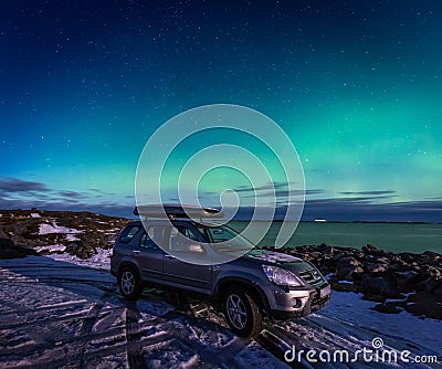 SUV car in the parking place under northen lights in Atlantic Ocean Road Editorial Stock Photo