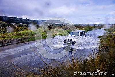 SUV fording river Stock Photo