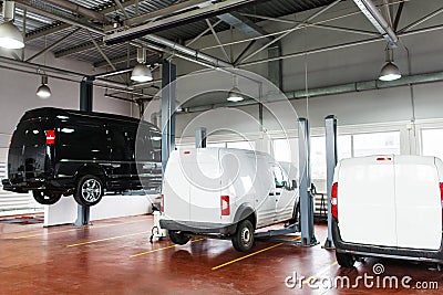 SUV service station, minibus raised up on lift Stock Photo