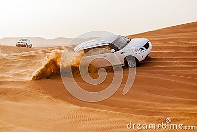 SUVs Trek Across the Desert Dunes Stock Photo