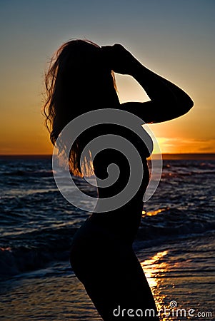 Svelte girl silhouette against the sunset Stock Photo