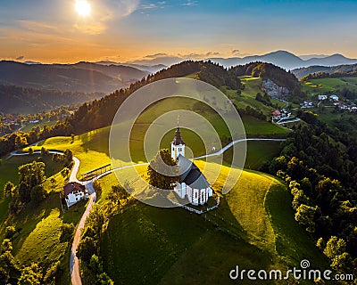 Sveti Andrej, Slovenia - Aerial drone view of Saint Andrew church Sv. Andrej at sunset in Skofja Loka area Stock Photo